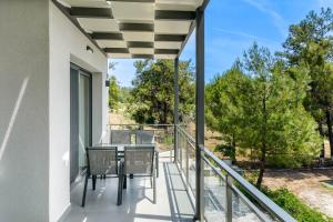a patio with a table and chairs on a balcony at Pine Suites in Potos