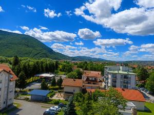 a view of a town with mountains in the background at Euforia Ma Apartment Sarajevo in Sarajevo