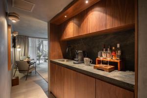 a kitchen with a counter with alcohol bottles on it at Casa Levora in Mexico City