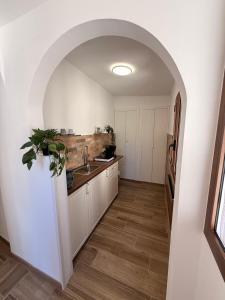 an archway in a kitchen with a sink at Casa Ma&Emy in Roccaporena +15 photos