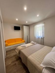 a small bedroom with a bed and a bench at Casa Ma&Emy in Roccaporena