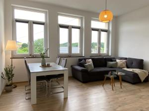 a living room with a couch and a table at Kreide & Kissen in Lünebach