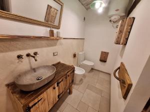 a bathroom with a sink and a toilet at Eco romantica in Baratti +19 photos