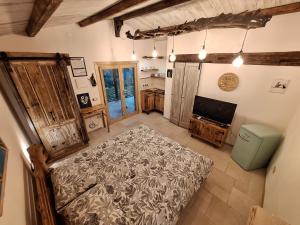 a bedroom with a bed and a television in a room at Eco romantica in Baratti