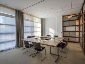 a conference room with a large wooden table and chairs at Mercure Cannes Mandelieu in Cannes +106 photos