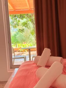 a bedroom with a bed and a large window at Rida Village Hotel Ksamil Island in Ksamil