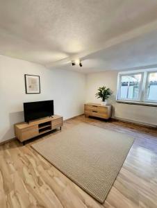 an empty living room with a flat screen tv at Wohnhaus mit besonderer Ausstrahlung in Bad Frankenhausen