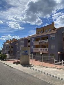 a building with a sign in front of it at Alma Marina Alcossebre - WiFi - Pet friendly - Aire Acondicionado in Alcossebre