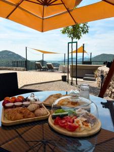 a table with two trays of food on it at Skyline Skadar Lake in Karuč
