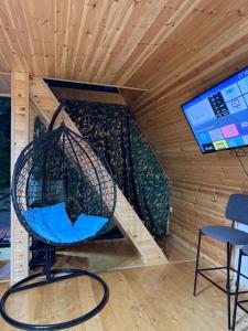 a room with a chair and a staircase at house milena in Kobuleti