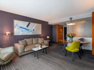 a living room with a couch and a table at Sofitel Luxembourg Europe in Luxembourg