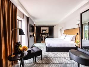 a hotel room with a bed and a desk at Sofitel Lisbon Liberdade in Lisbon