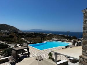 a view of a swimming pool and the ocean at Rineia Complex by Live&Travel in Mikonos