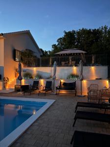 a patio with a swimming pool at night at Holiday Home Calma in Imotski