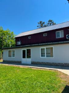 a large white building with a red roof at Liza's house - Block A in Ureki