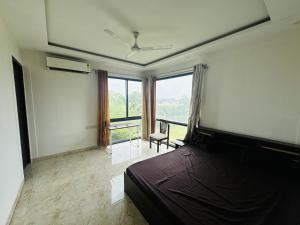 a bedroom with a bed and a large window at Rk farms in Noida
