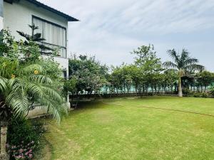 a yard next to a house with a fence at Rk farms in Noida +17 photos