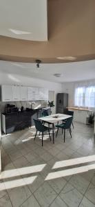 a kitchen with a table and chairs in a room at The HOME in Ditrău +13 photos