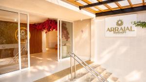 a entrance to a shopping mall with a sign on the wall at Arraial Concept Hotel in Arraial do Cabo