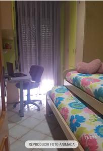 a bedroom with a desk and a laptop computer at Casa Maite in Palamós