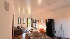a living room with a refrigerator and a table at Casitas Atlántida in Atlántida