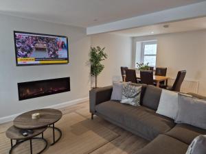 a living room with a couch and a fireplace at Harbour View House in Ballycastle