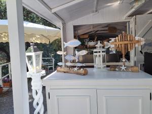 a porch with a table with chandeliers on it at Bed and Breakfast Tenuta Palmieri ONLY ADULT in Maratea