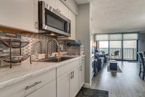 a kitchen with a sink and a living room at Pool Access: 8th-Floor Condo on North Myrtle Beach in Myrtle Beach