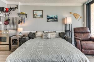 a bedroom with a bed and a chair at Pool Access: 8th-Floor Condo on North Myrtle Beach in Myrtle Beach +19 photos