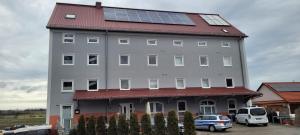 a large building with solar panels on its roof at Hotel Zachskorn UG in Erdweg