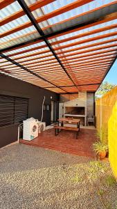 a patio with awning and a bench and a table at Casitas Atlántida in Atlántida