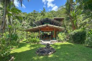 a small house in the middle of a yard at Casa Aire Libre - Jungle immersion - Natural pool - Waterfall in Puerto Jiménez