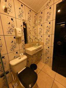 a small bathroom with a toilet and a sink at Casa Chapadeira in Colinas Do Sul +19 photos