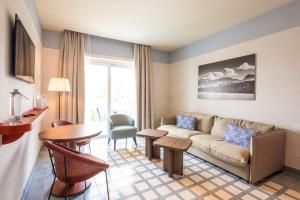 a living room with a couch and a table at Hotel Plaza in Sorrento