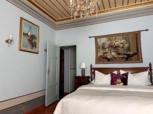 a bedroom with a bed and a painting on the wall at Villa Amore Tuscany in Capannori