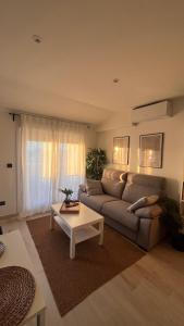 a living room with a couch and a table at AuraGalega Vionta in Ribeira