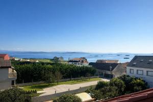 a view of a town with the ocean in the background at AuraGalega Vionta in Ribeira