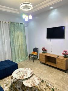 a living room with a flat screen tv on a wall at Apartment Luxueux a Cité Apix in Niadyorane