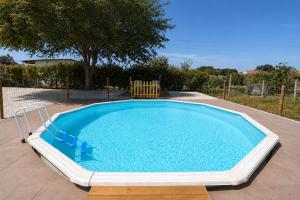 a large swimming pool in a yard at Chicas Country House in Amieira