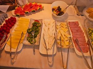 a table topped with different types of cheese and appetizers at Villa Olympia in Durrës