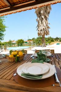 a table with a plate on top of a wooden deck at Chicas Country House in Amieira