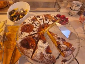 a plate of food with a cake on a table at Villa Olympia in Durrës