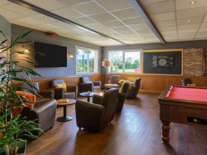 a waiting room with couches and a pool table at ibis Falaise Coeur de Normandie in Falaise
