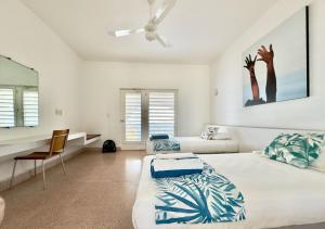 a white bedroom with two beds and a desk at Acantilado Acapulco in Acapulco +155 photos