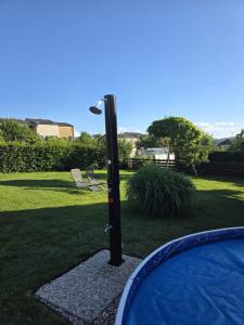 a pole with a light in the middle of a yard at Štramberk roubenka in Štramberk