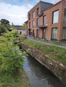 a river in front of a brick building at Komfortables 2-Zimmer Apartment in Rinteln in Rinteln