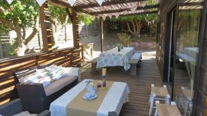 a patio with a couch and a table and chairs at Casa punta de lobos in Pichilemu +11 photos