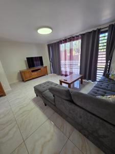 a living room with a couch and a table at Feri Lodge in Tohautu