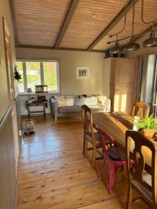 a dining room with a large wooden table and chairs at Smedjan Bed and Breakfast in Varberg +19 photos