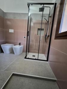 a bathroom with a shower and a toilet at House Manu in Assemini